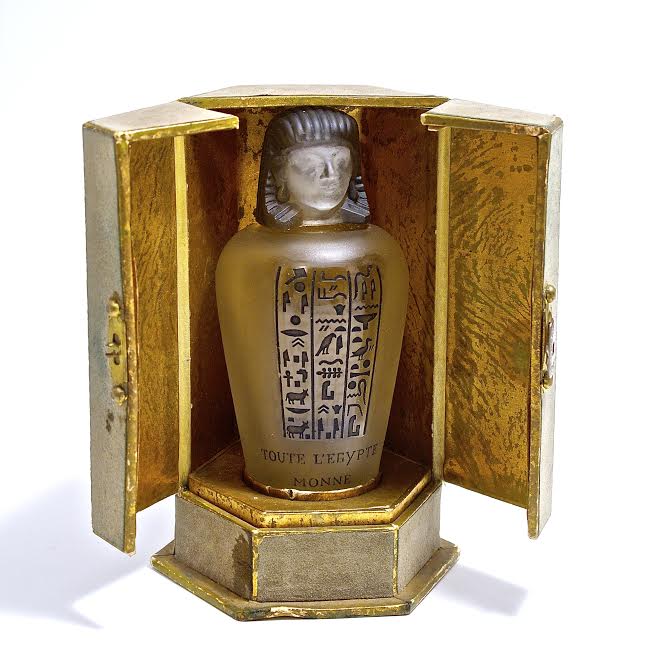 1917 Baccarat, Monne Toute I’Egypte perfume bottle, cover, inner stopper; clear/frost crystal molded  label black patina. Baccarat mark, box 4 1/8 in.