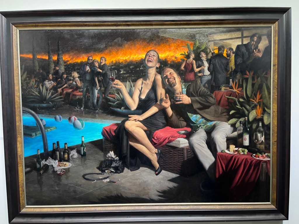 figures at a party with a fire in the background. 
