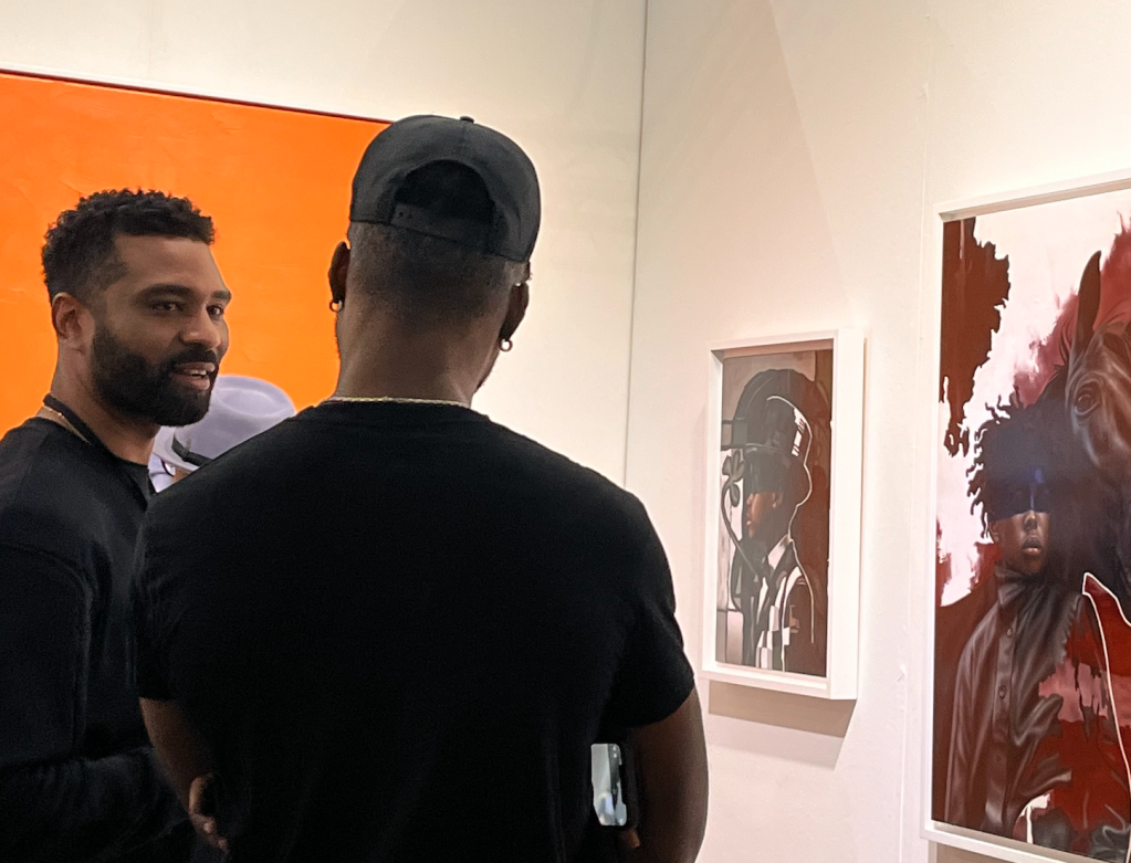O’Neil Scott speaks with a patron at the LA Art Show
